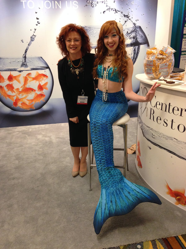 Hart Communications partner Kathleen Hart with a model 'mermaid' at a medical conference