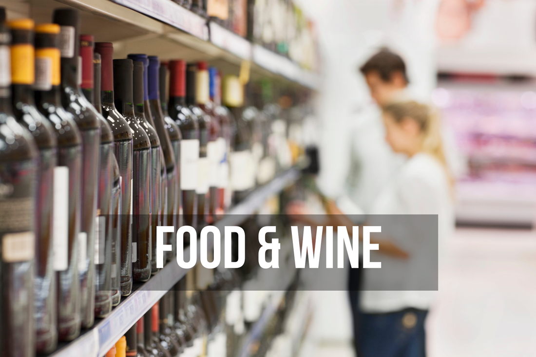 Headline 'food and wine' over a couple in a supermarket is choosing a wine to buy from a crowded shelf